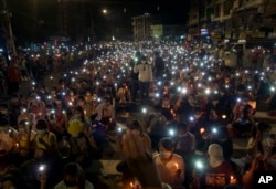 Anti-coup protesters turn on the LED light of their mobile phones during a candlelight night rally in Yangon, Myanmar Sunday, March 14, 2021.