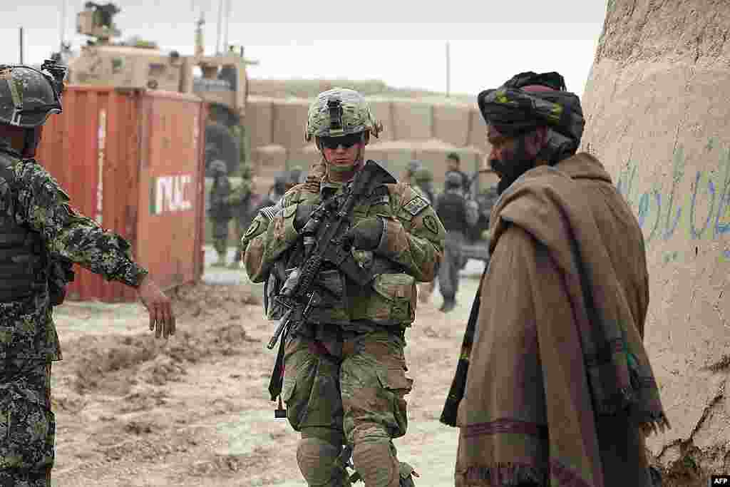 A U.S. soldier, part of the NATO-led International Security Assistance Force (ISAF), stands outside a military base in Panjwai. (AP)