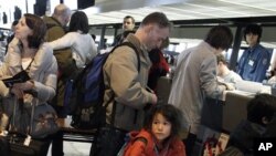 French residents in Japan and French citizens prepare to check in to a special charter flight to Paris, at Narita airport, March 17, 2011