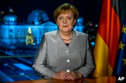German Chancellor Angela Merkel poses for a photograph after the recording of her annual New Year's speech at the Chancellery in Berlin, Germany, Dec. 30, 2018.