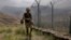 FILE - In this Aug. 3, 2021 file photo, Pakistan Army troops patrol along the fence on the Pakistan Afghanistan border at Big Ben hilltop post in Khyber district, Pakistan.