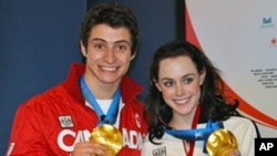 Canadian ice dancers Scott Moir and Tessa Virtue with their gold medals