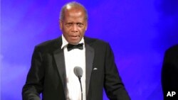 FILE - Sidney Poitier speaks at the 2016 Carousel Of Hope Ball in Beverly Hills, Calif., Oct. 8, 2016.