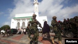 FILE - Soldiers serving in the African Union Mission in Somalia (AMISOM) patrol outside a Mosque during Eid al-Fitr prayers, marking the end of the fasting month of Ramadan at a Mosque in Somalia's capital Mogadishu, July 17, 2015.