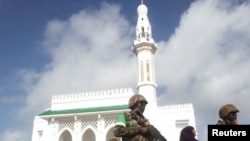 Soldiers serving in the African Union Mission in Somalia (AMISOM) patrol outside a Mosque during Eid al-Fitr prayers, marking the end of the fasting month of Ramadan at a Mosque in Somalia's capital Mogadishu, July 17, 2015.
