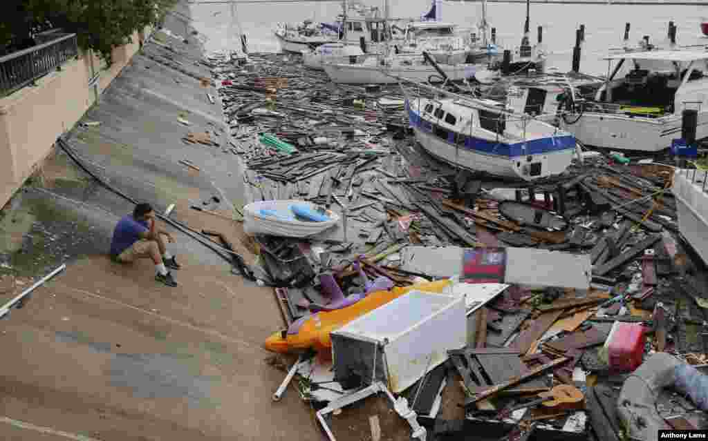 Allen Heath surveys the damage to a private marina after it was hit by Hurricane Hanna in Corpus Christi, Texas.