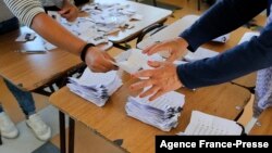 An electoral staffer counts ballots after the polls closed at the Gualberto Kong Fernandez Basic School in Vallenar, Chile, Nov. 21, 2021.