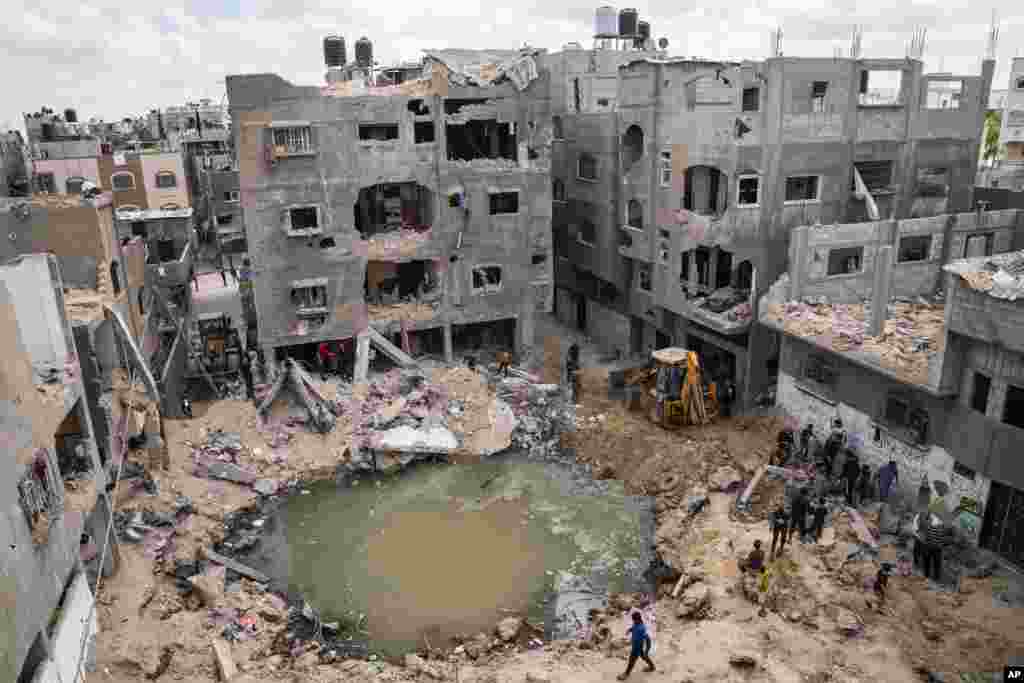 A crater full of water and sewage is seen where the home of Ramez al-Masri was destroyed by an Israeli airstrike in Beit Hanoun, the northern Gaza Strip, after an 11-day war between Gaza&#39;s Hamas rulers and Israel.