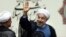 Iran's new President Hasan Rouhani, waves after swearing in at the parliament, in Tehran, Iran, Sunday, Aug. 4, 2013. Iran's new president on Sunday called on the West to abandon the "language of sanctions" in dealing with his country over its contentious nuclear program, hoping to ease the economic pressures now grinding its people. Rouhani spoke after being sworn in as president. Aug. 4, 2013.