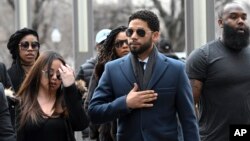 Empire actor Jussie Smollett, center, arrives at the Leighton Criminal Court Building for his hearing on March 14, 2019, in Chicago. 