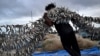 Fishermen unload their catch from a traditional boat at Kedonganan beach, Badung regency on the resort island of Bali, Indonesia, Jan. 12, 2025.