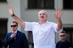 FILE - Belarusian President Alexander Lukashenko gestures as he greets his supporters gathered at Independent Square of Minsk, Belarus, Aug. 16, 2020.