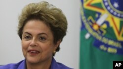 FILE - Brazil’s President Dilma Rousseff meets with women rural workers at Planalto Presidential Palace in Brasilia, Aug. 6, 2015.