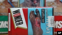 FILE - The warning signs are printed on the cigarette packets on sale in Bangkok, Thailand.