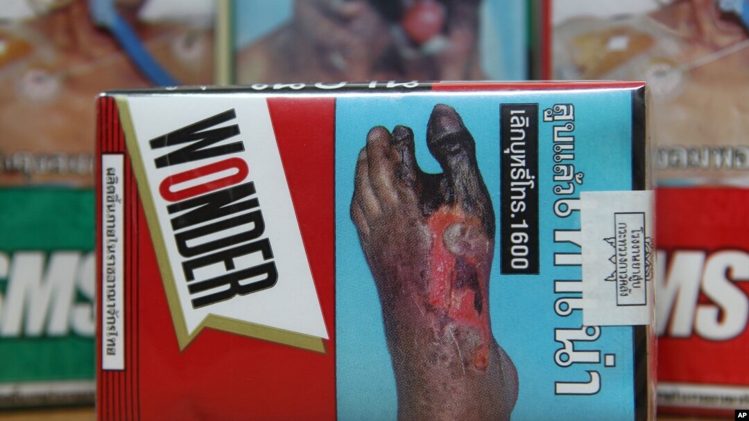 FILE - The warning signs are printed on the cigarette packets on sale in Bangkok, Thailand.