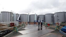 Workers are seen near storage tanks for radioactive water at Tokyo Electric Power Co's (TEPCO) tsunami-crippled Fukushima Daiichi nuclear power plant in Okuma town, Fukushima prefecture, Japan January 15, 2020. Picture taken January 15, 2020. (REUTERS/Aar