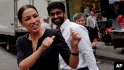 Alexandria Ocasio-Cortez, the winner of a Democratic Congressional primary in New York, greets a passerby in New York, June 27, 2018, the morning after she upset U.S. Rep. Joe Crowley in Tuesday's primary election. 