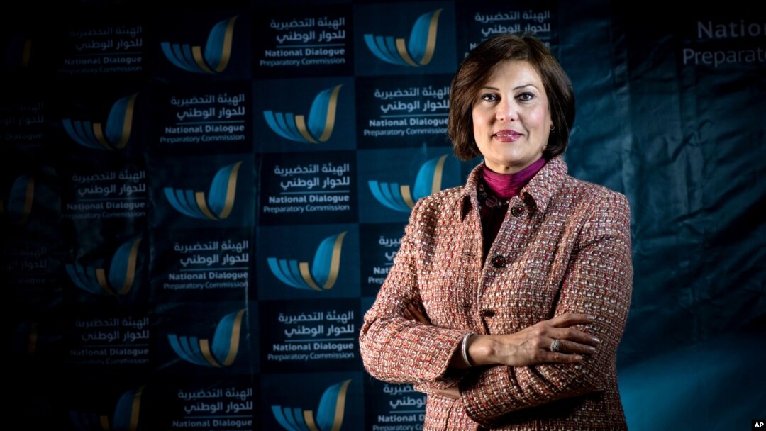 In this March 2014 image released by the National Dialogue Preparatory Commission, Salwa Bugaighis, lawyer and rights activist, poses for a photograph during a meeting in Tripoli, Libya
