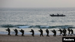 FILE - Pakistan Navy's special service group conduct a maritime counter-terrorism demo during an exercise in Karachi, Pakistan February 9, 2019.