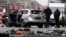 Police inspect the scene of a damaged Volkswagen car in the Bismarckstrasse in Berlin, Germany March 15, 2016. German police said on Twitter that they believe an explosive device caused a car to explode while it was driven along a road in central Berlin o