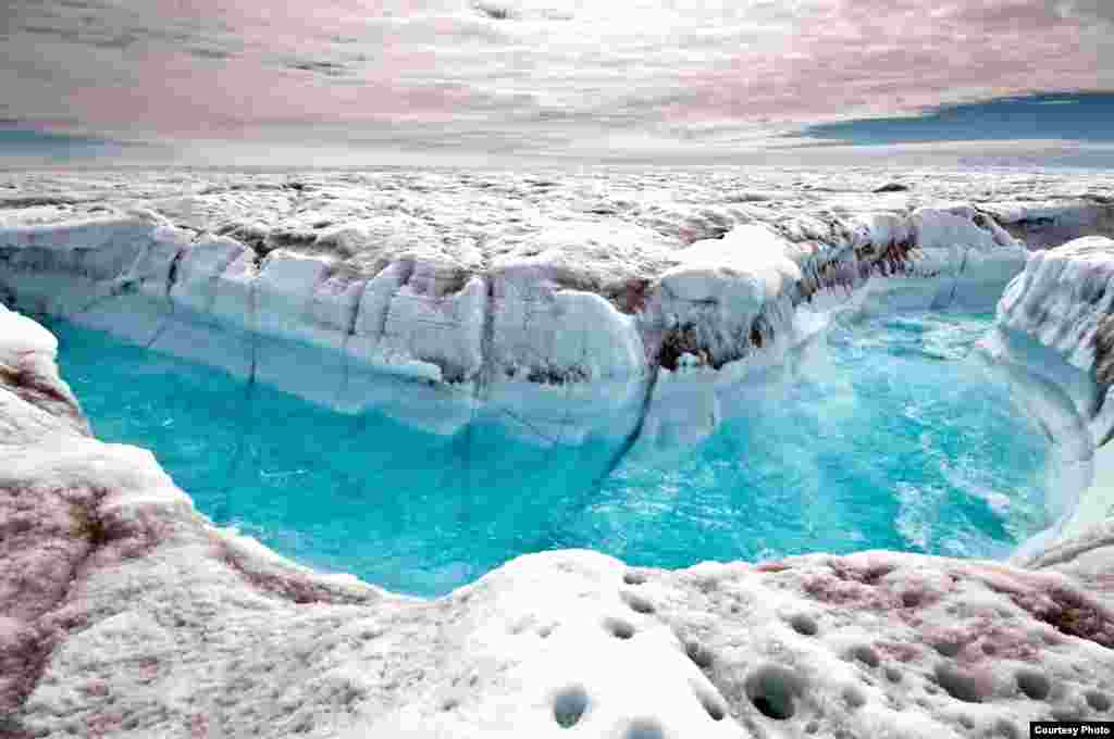 In 2012 polar ice sheets melted at an accelerating rate. In this photo surface melt water rushes along the surface of the Greenland Ice Sheet through a supra-glacial stream channel. (Ian Joughin)