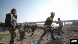 Сотрудники миротворческой организации «Белые каски» убирают тела погибших после российского авиаудара. Сирия, Идлиб, декабрь 2019 г. 