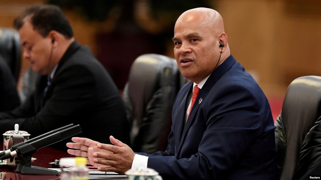 FILE - Micronesia's President David Panuelo talks with China's President Xi Jinping (not pictured) at the Great Hall of the People in Beijing, China, Dec. 13, 2019. Panuelo is alleging that Chinese agents followed him during a recent trip to Fiji.