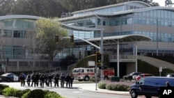 Law enforcement officials walk toward YouTube offices in San Bruno, Calif., April 3, 2018. 