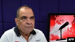 FILE - Radio Globo and Globo TV director David Romero reacts when police officers burst into the radio studio to arrest him in Tegucigalpa, Honduras, March 28, 2019.