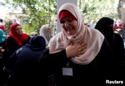 A Palestinian UNRWA employee reacts during a protest against jobs termination by UNRWA inside its headquarters in Gaza City, July 25, 2018.