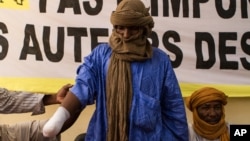 Alhader Ag Almahmoud, a 30-year-old Tuareg herder whose right hand was amputated last month by an Islamist group, displays his bandaged arm at an Amnesty International press conference in Bamako, Mali, September 20, 2012.