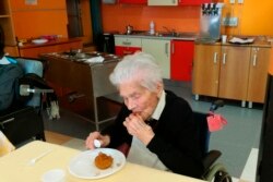 In this photo taken on April 6, 2020, 103-year-old Ada Zanusso, eats her meal at the nursing home "Maria Grazia" in Lessona, northern Italy, after recovering from Covid-19 infection. (Residenza Maria Grazia Lessona via AP Photo)