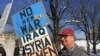 Protester who is against the wars in Syria and Yemen in Manchester, New Hampshire, Feb. 8, 2016. (Photo. A. Pande / VOA)