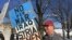 Protester who is against the wars in Syria and Yemen in Manchester, New Hampshire, Feb. 8, 2016. (Photo. A. Pande / VOA)