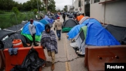 Migrants who are seeking asylum in the United States set up a makeshift encampment near the U.S. border with Brownsville, Texas, after the U.S. Supreme Court said Title 42 should stand as is for now, in Matamoros, Mexico Dec. 20, 2022.