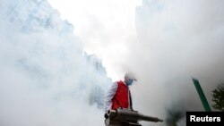 A volunteer disinfects a residential compound to prevent and control the novel coronavirus, in Ganzhou, Jiangxi province, China February 6, 2020. 