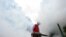 A volunteer disinfects a residential compound to prevent and control the novel coronavirus, in Ganzhou, Jiangxi province, China February 6, 2020. 