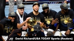 The Golden State Warriors celebrate after defeating the Cleveland Cavaliers to win the 2018 NBA Finals at Quicken Loans Arena, June 8, 2018, in Cleveland, Ohio.