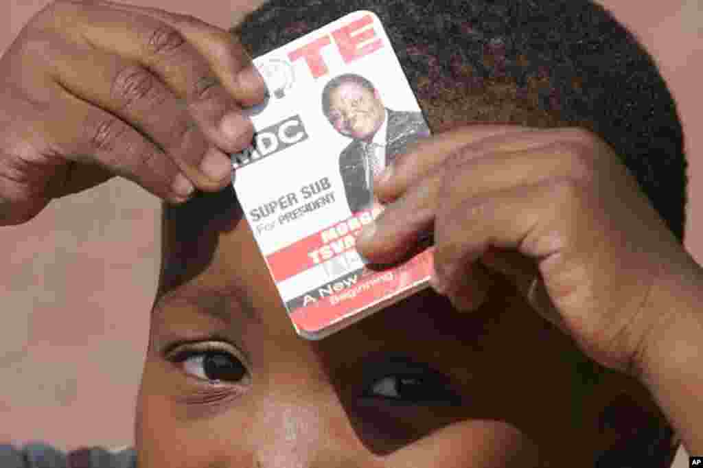 A child holds a sticker at a Movement for Democratic Change (MDC) supporters rally for those lliving in exile in South Africa at a protest rally in Johannesburg. The Movement for Democratic Change, which claimed its leader Morgan Tsvangirai won the March 29 presidential ballot said it would not accept a recount, did not want a runoff and pressed ahead with legal attempts to force the publication of the results.