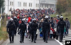 A group of migrants walks toward Austria from a camp in Sentilj, Slovenia, Oct. 25, 2015.