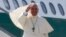 Pope Francis waves as he boards his plane to leave for his pastoral visit to South Korea, at the Fiumicino airport in Rome, Aug. 13, 2014. 