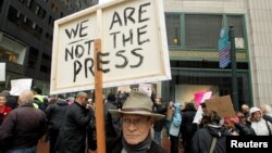 FILE - Tom Martin carries a sign protesting U.S. President Donald Trump's refusal to release his income tax returns near the hotel where House and Senate Republicans are attending a retreat in Philadelphia, Pennsylvania, Jan. 26, 2017.