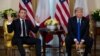 President Donald Trump, right, listens as French President Emmanuel Macron speaks at their meeting at Winfield House during the NATO summit, in London, Dec. 3, 2019.