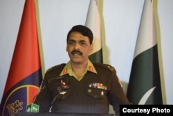 FILE - Major-General Asif Ghafoor holds a press briefing, Dec. 27, 2017, in this his handout picture made available by Pakistan's Army's media wing, ISPR.