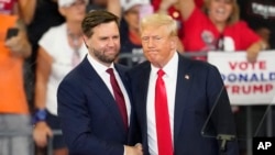 FILE - Republican vice presidential candidate Sen. JD Vance and Republican presidential candidate former President Donald Trump, shake hands at a campaign rally in Atlanta, Aug. 3, 2024.