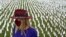 Artist Suzanne Brennan Firstenberg stands among thousands of white flags planted in remembrance of Americans who have died of COVID-19, part of her art installation, near Robert F. Kennedy Memorial Stadium in Washington, D.C., Oct. 27, 2020.