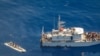 FILE - An aerial view shows a Libyan coast guard ship with migrants on deck, in a search and rescue zone off Libya's coast, May 11, 2019, as seen from Germany's Sea-Watch humanitarian organization's Moonbird aircraft. 