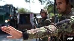 Afghan National Army soldiers search vehicles at a checkpoint in the city of Jalalabad on Aug. 1, 2018. Afghanistan ramped up security in Jalalabad on August 1, a day after militants stormed a government office in Nangarhar province.