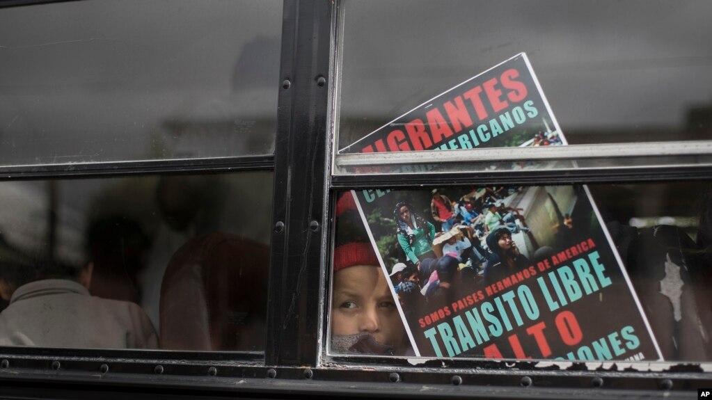 A Central American child who is traveling with a caravan of migrants, peers from a bus carrying the group to the U.S. border in Tijuana, Mexico, April 29, 2018. 