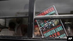 A Central American child who is traveling with a caravan of migrants, peers from a bus carrying the group to the U.S. border in Tijuana, Mexico, April 29, 2018. 